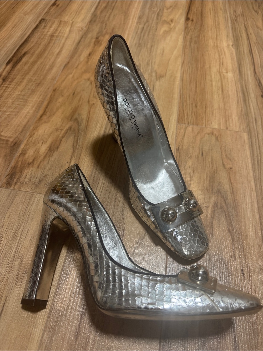 Dolce & Gabbana Silver Python-Effect Stiletto Pumps with Decorative Orb Accent.